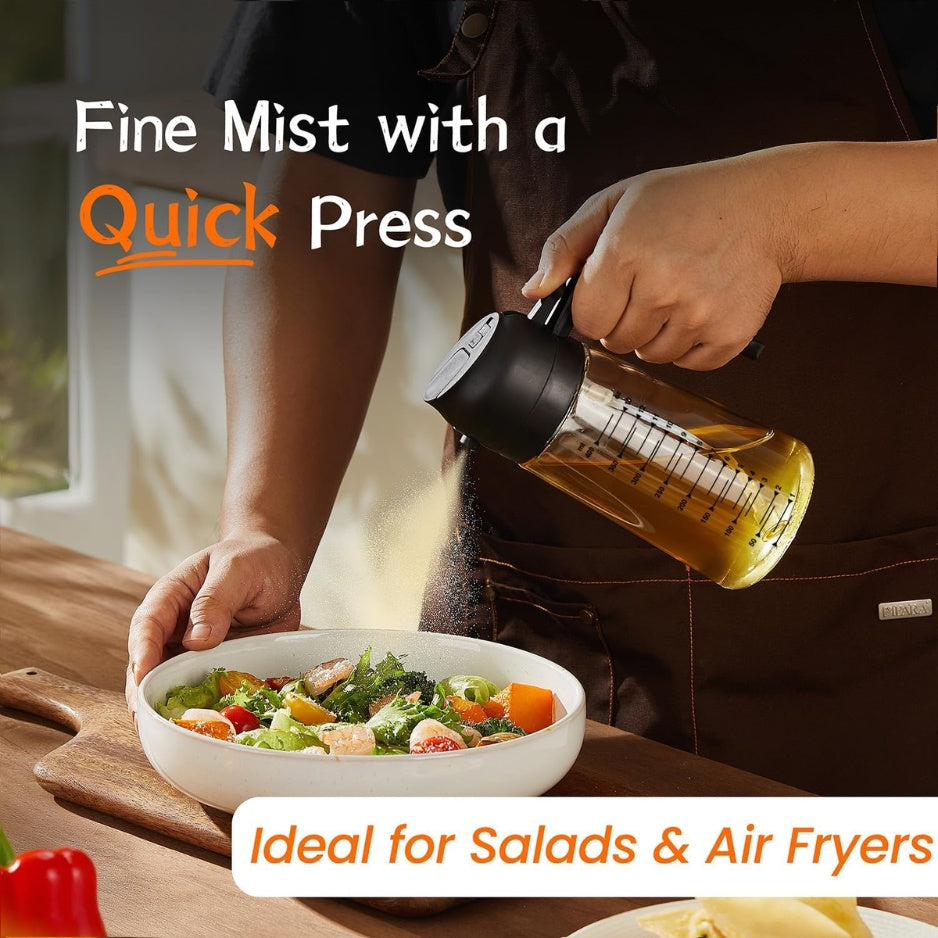 Glass olive oil dispenser next to fresh salad ingredients